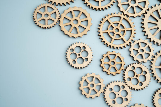 Interlocking wooden gears symbolize teamwork in business.