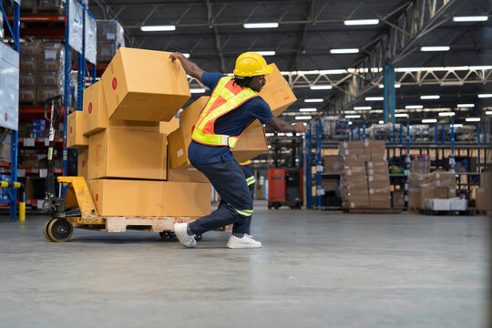 Warehouse worker accident at work. Warehouse worker falling down on concrete floor after cardboard boxes collapsed fell from wooden pallet cart, occupational workplace safety accident concept