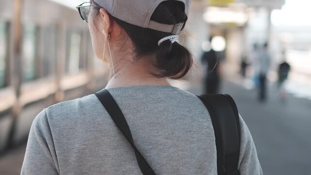 Rear View of Woman Walking on Train Station Platform in Slow Motion