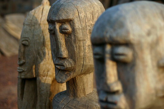 Close up of carved Dogon wooden statues with elongated faces, Mopti Region, Bandiagara, Mali