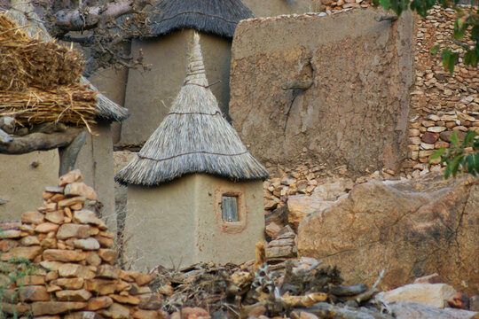 Dogon clay granary with a pointed thatched roof and a small window, Mopti Region, Bandiagara, Mali