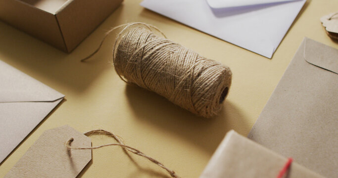 Image of box, envelopes, tags and string on green background