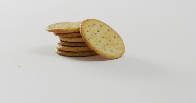 Image of stack of cheese biscuits on white background with copy space