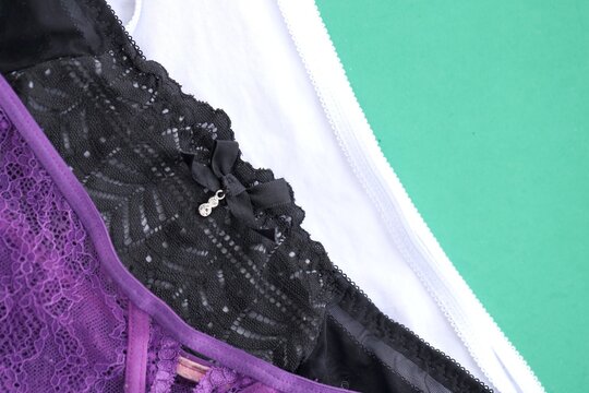 Women panties on green table in clothes shop close up