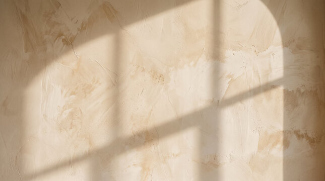 Beige plaster wall texture with natural window shadow for mockup background.
