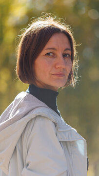 Soft sunlight highlights a woman's gentle expression