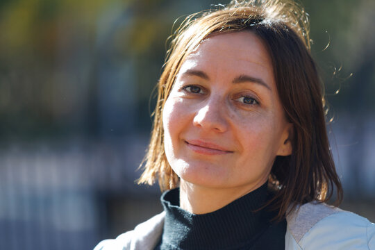 Warm sunlight glows behind a woman's shoulder