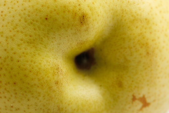 Golden-yellow pear with charming brown speckles