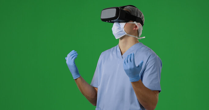 Surgeon in scrubs explores virtual reality, with copy space