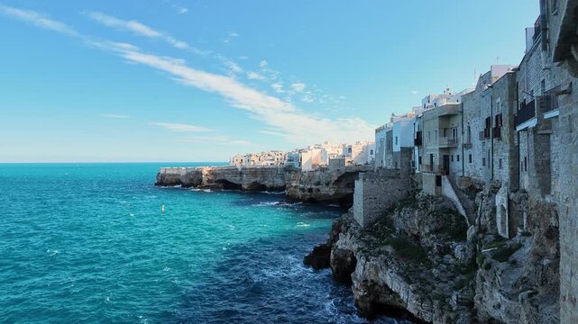 Elevated view of cliffside houses above the turquoise sea, Polignano a Mare, Italy