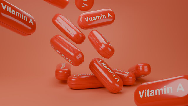 3D render of multiple red glossy Vitamin A supplement capsules falling on red background, healthcare and nutrition concept