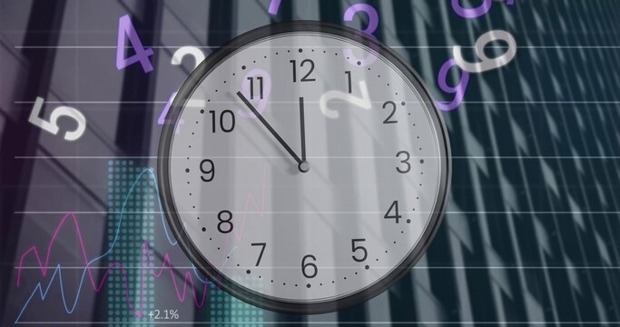 Framing analog clock silver bezel showing Arabic numerals over tower facade, showing financial data