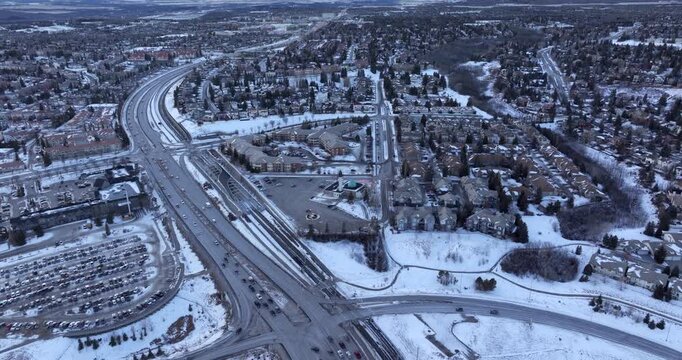 Aerial flyover of 17th Avenue SW and Sarcee Trail with light traffic in winter, Calgary, Alberta, Canada.	