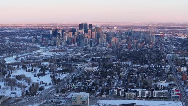 Aerial view of the downtown Calgary skyline and surrounding neighborhoods at sunset during winter, Alberta, Canada.	