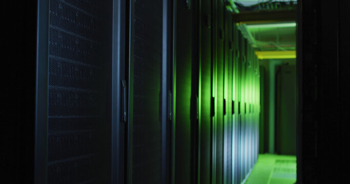 Green control lights reflected on computer servers in tech room