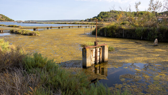 Abandoned salines of Peyriac de Mer, Aude, France, with the famous boardwalk, and out of use water management structure