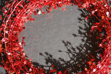 Red star garland with copy space. Christmas greetings, holiday promotions, seasonal advertisements © TatiG