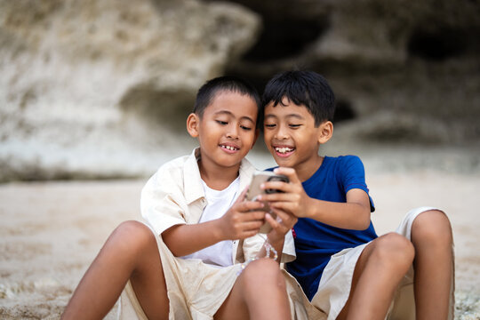 Candid portrait of happy brothers laughing and sharing a joyful moment together
