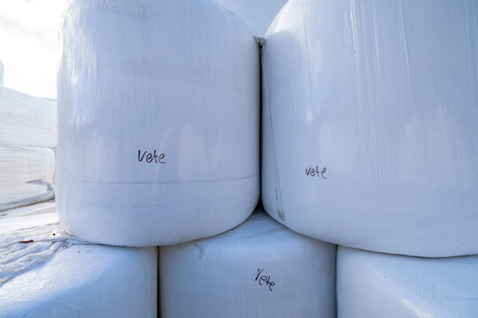 Nykoping, Sweden Large stacked hay bales wrapped in white plastic.