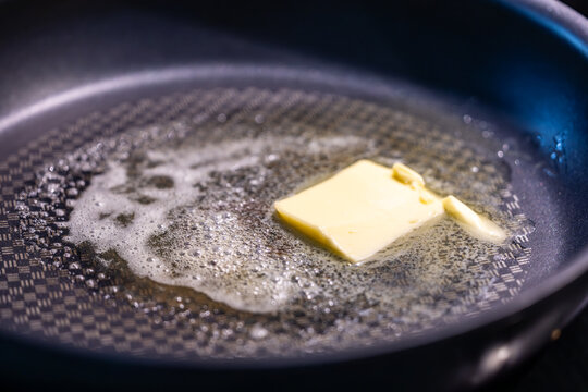 Stockholm, Sweden, A chunk of butter meltin gin a frying pan.
