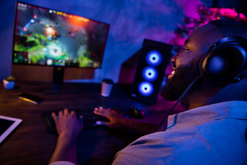 Profile portrait of handsome cheerful person enjoy playing videogame  look monitor screen late night room © deagreez