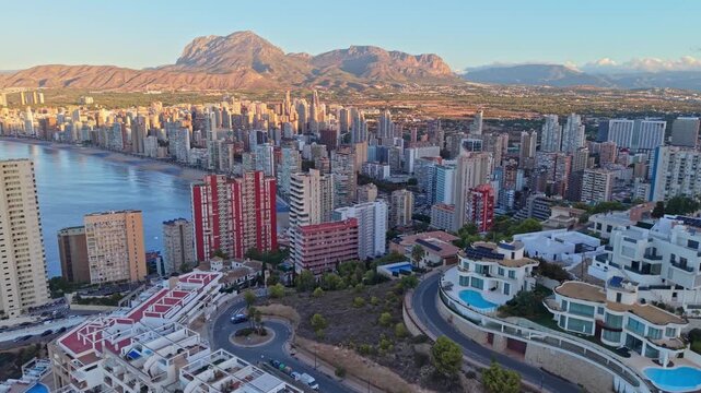 Aerial view of the dense high-rise skyline and sandy beach of Benidorm, Valencian Community, Spain.