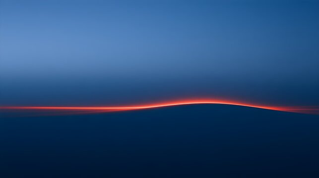 Sunset over a mountain with a glowing horizon