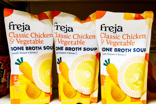 Close-Up Of Three Pouches Of Freja Classic Chicken And Vegetable Bone Broth Soup On A Supermarket Shelf