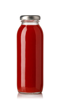 Red tomato juice in a sealed glass bottle isolated on white