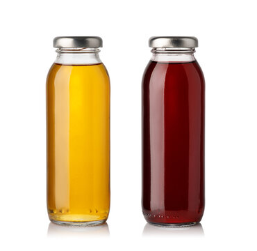Glass beverage bottles with golden and red juice