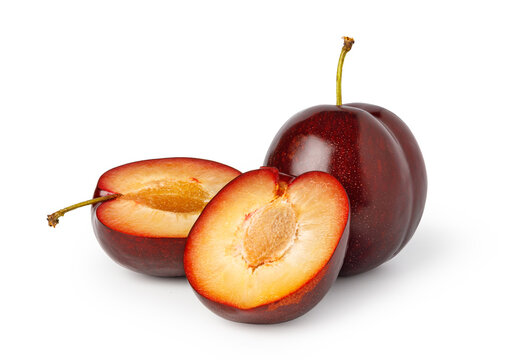 Ripe plum with two cut halves on a clean white background