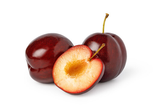 Red plums, whole and halved, with golden flesh