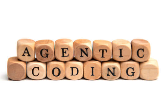 The term "agentic coding" spelled out with wooden blocks &ndash; a symbolic representation of AI-powered software development