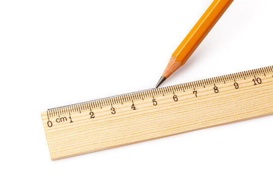 Pencil drawing a line beside a wooden centimeter ruler