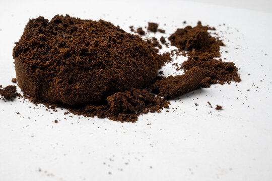 Used Coffee Grounds on White Background
