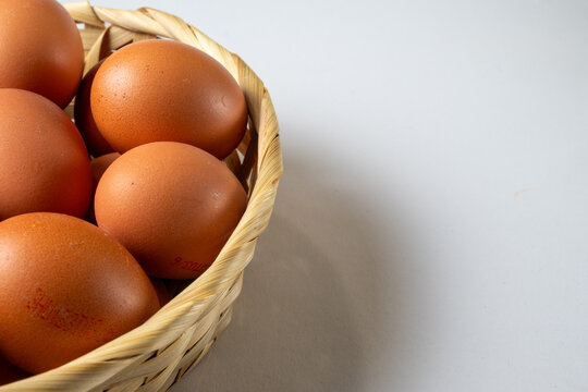Brown Eggs in Woven Basket with Copy Space
