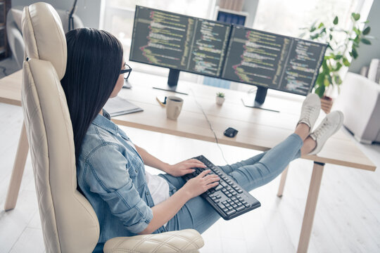 Profile side view portrait of attractive focused girl web expert leader editing code developing project start-up at workplace workstation indoors