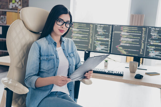 Portrait of attractive experienced girl top hr director technician reading resume cv research at workplace workstation indoors