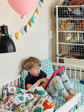 Boy sitting on his bed