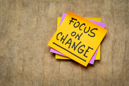 focus on change inspirational advice or reminder - handwriting on a sticky note, lifestyle and personal development concept