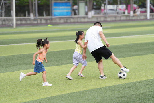 Children Play Soccer at a Park During a Sunny Afternoon