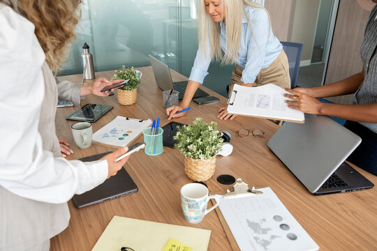 Diverse businesswomen collaborating on project during office meeting