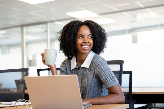 African american businesswoman working on laptop smiling at office