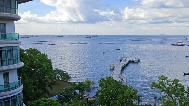 Aerial View from Luxury Hotel Balcony Overlooking Pier and Cargo Ships in Si Racha Bay Thailand