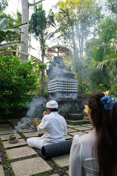 Ceremony in a Garden With Smoke and Offerings in Bali