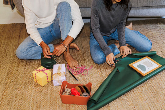 Couple wrapping gifts for holidays and special occasions