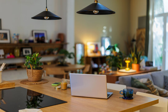 Laptop sitting on kitchen counter in modern home