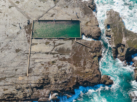 Ocean bath swimming pool on a large rock ledge at low tide