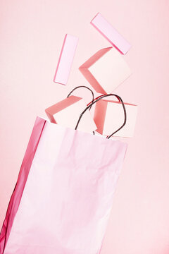 Pink paper shopping bag full of pink cardboard packages. Mockup