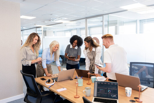 Diverse business team collaborating on project in modern office
